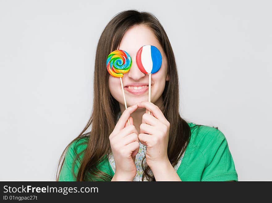 Smiling girl with lollipops, studio shot