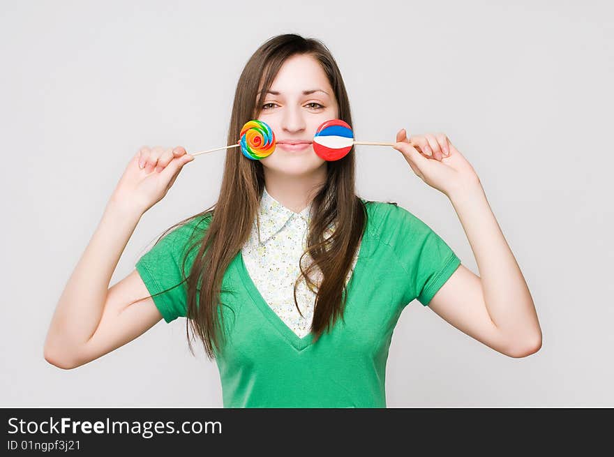 Attractive girl with lollipops, studio shot