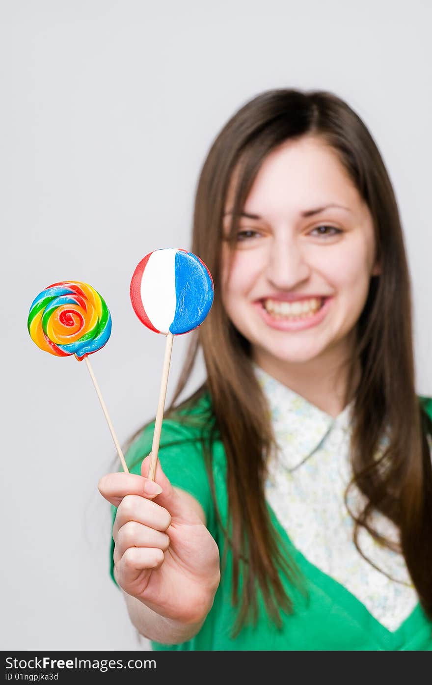 Smiling girl with lollipops