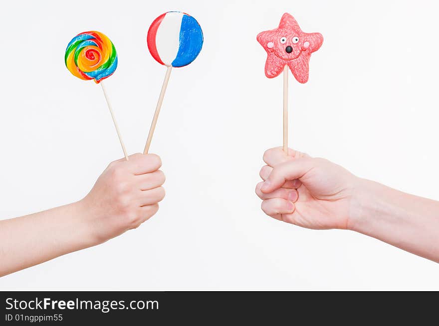 Hands with lollipops, studio shot