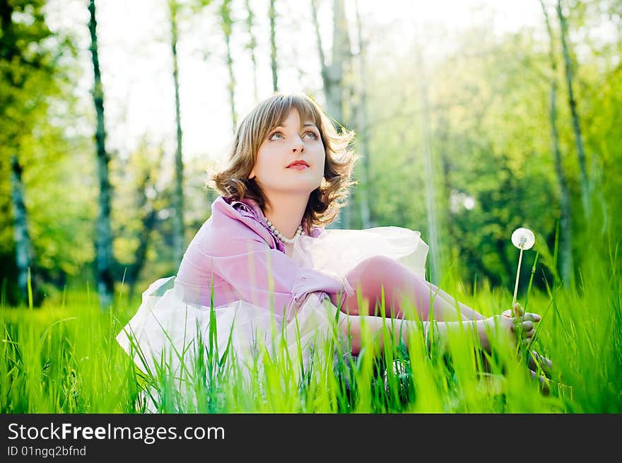 Romantic girl outdoors in perfect green grass