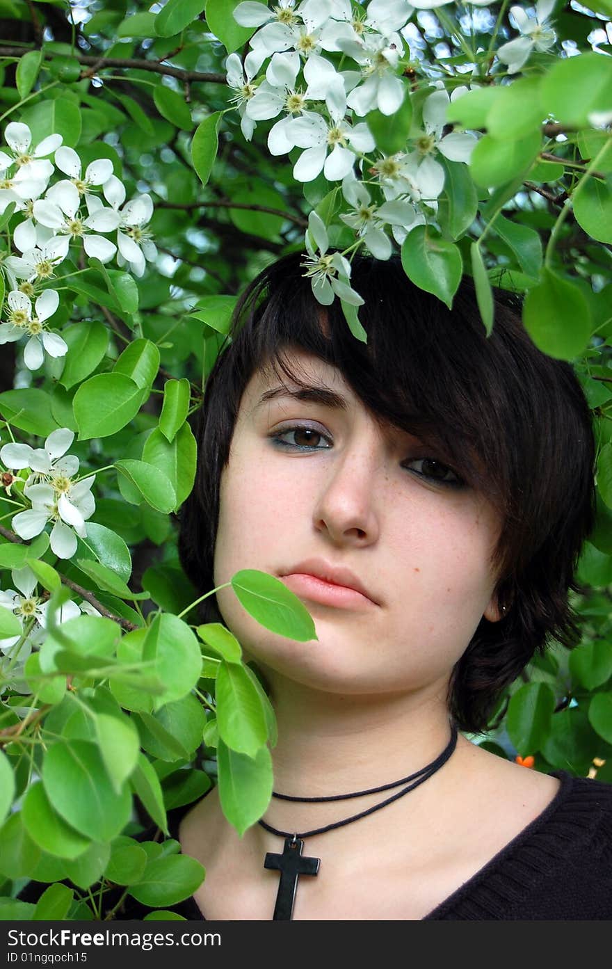 Portrait of young brunette in the spring garden. Portrait of young brunette in the spring garden