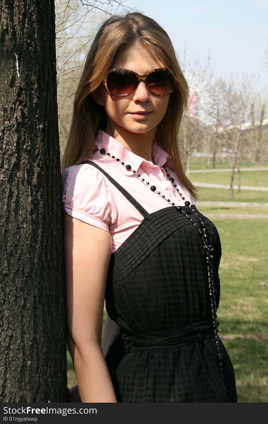 Girl standing near a tree in a park