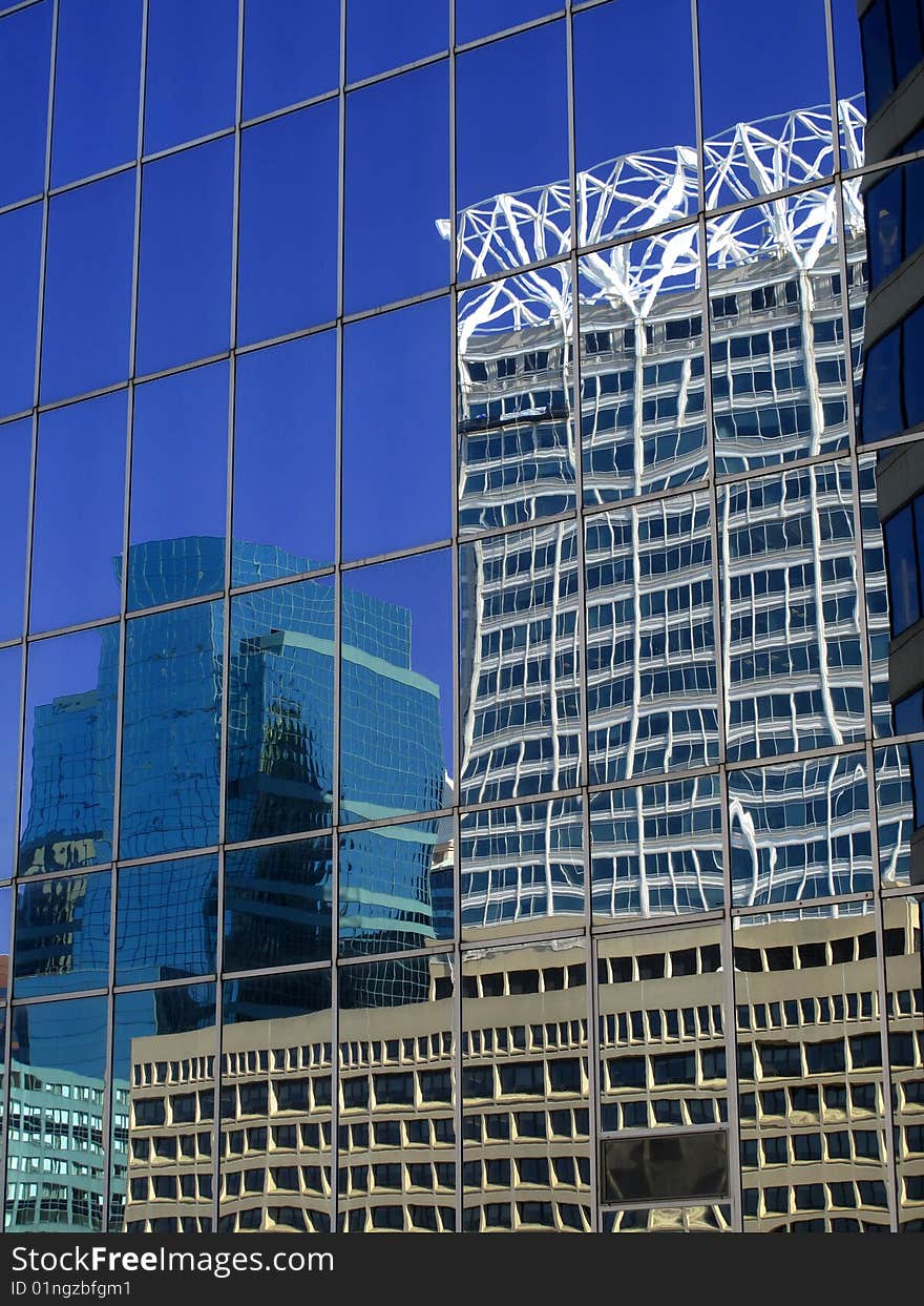 Office building details reflecting blue sky and clouds in windows. Office building details reflecting blue sky and clouds in windows