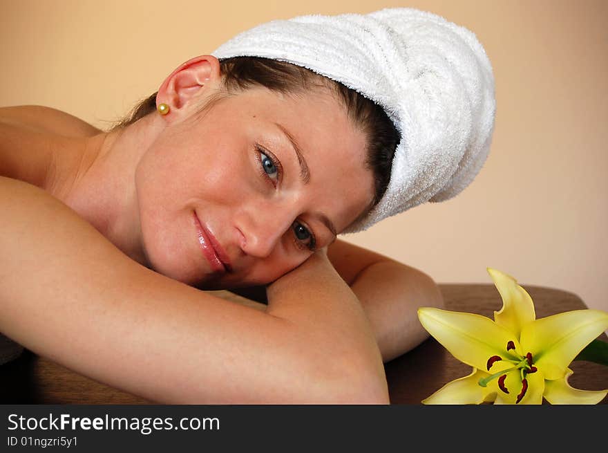 Pretty woman with flower relaxing in spa. Pretty woman with flower relaxing in spa