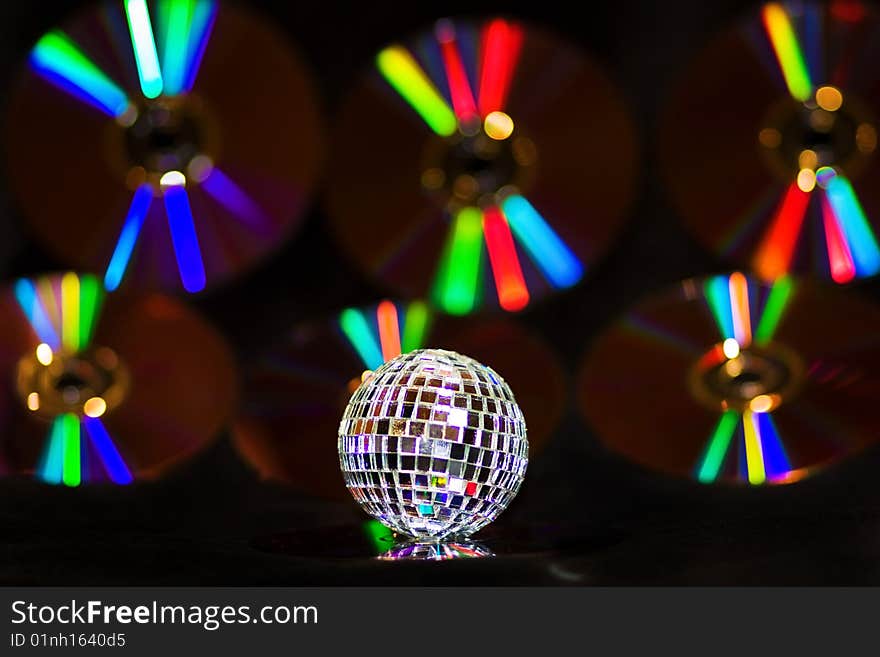 Disco Ball over music CDS with rainbow reflections