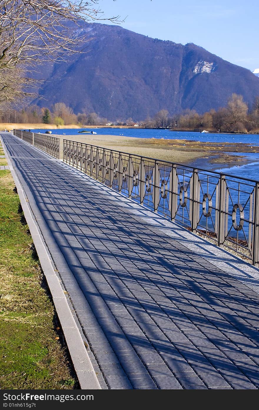 Sidewalk along the lake with railing