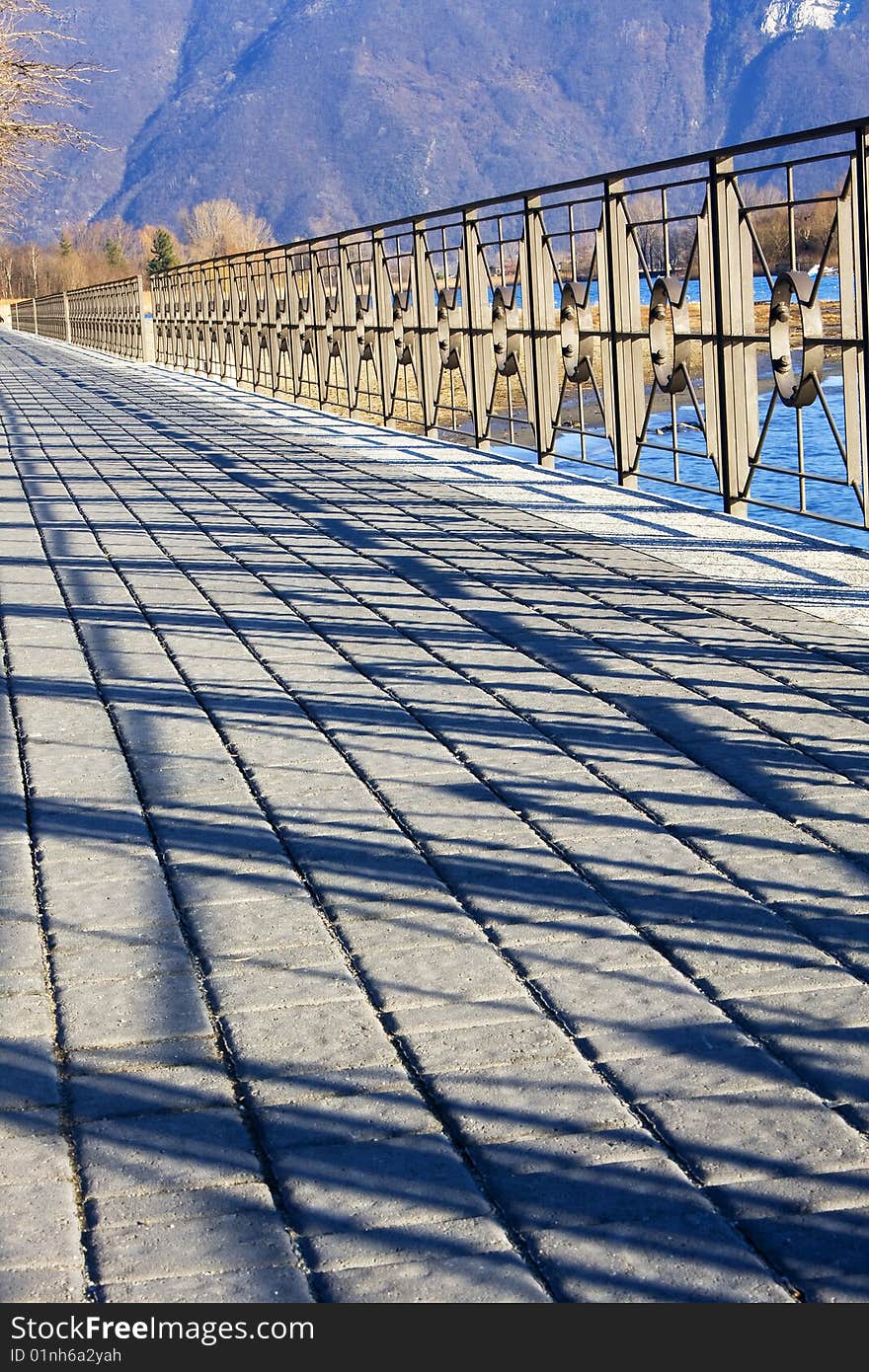 Sidewalk along the lake with railing