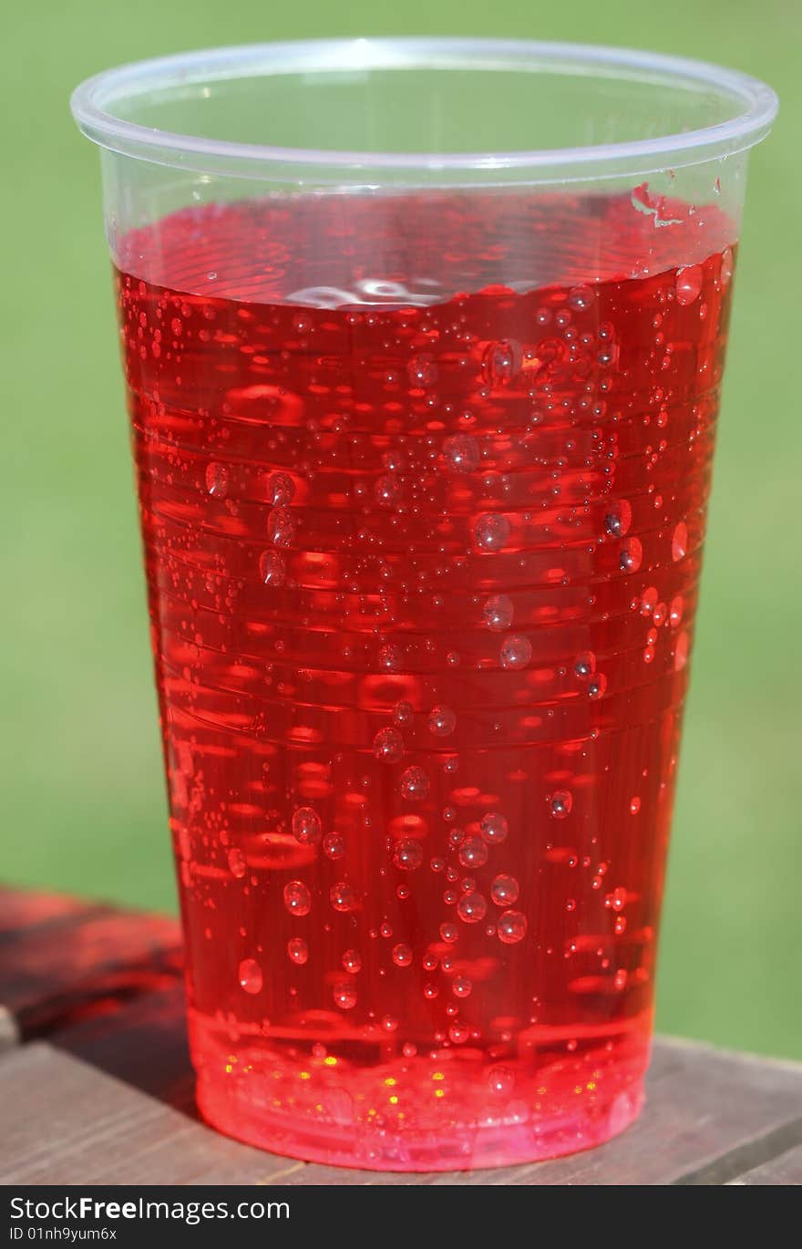 Pot of red seedy lemonade on summer