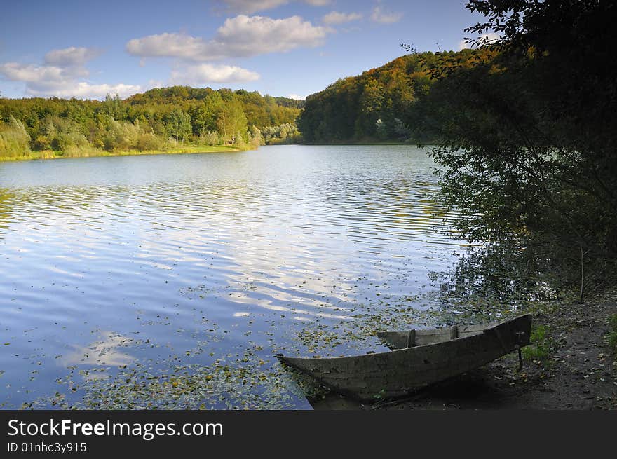 Early autumn on the lake, and the forest which begins to change color. Early autumn on the lake, and the forest which begins to change color