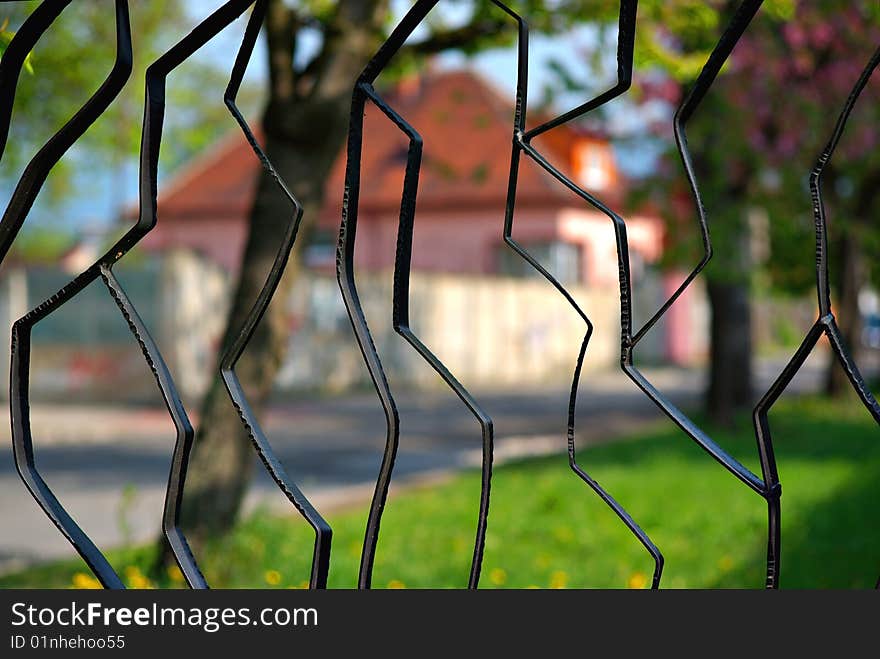 Detail of a black metal fence with a view to the street