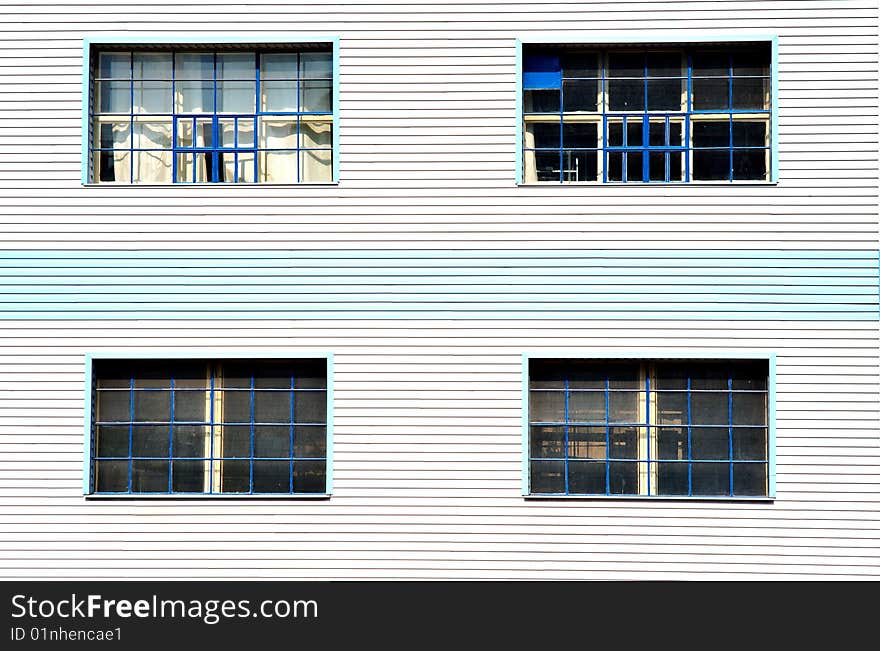 Windows on blue white facade