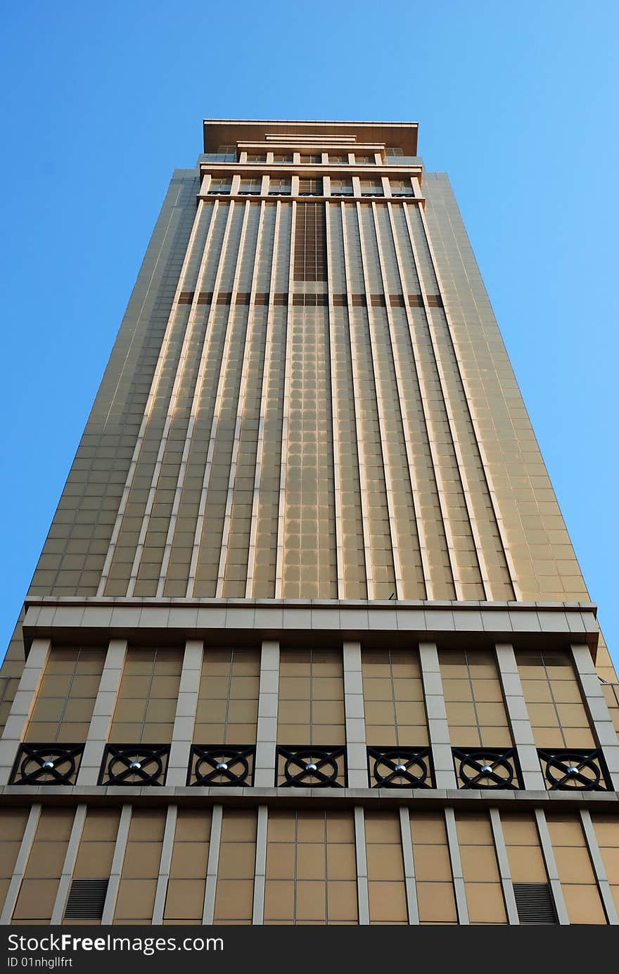 Golden Commercial Building towering to blue sky