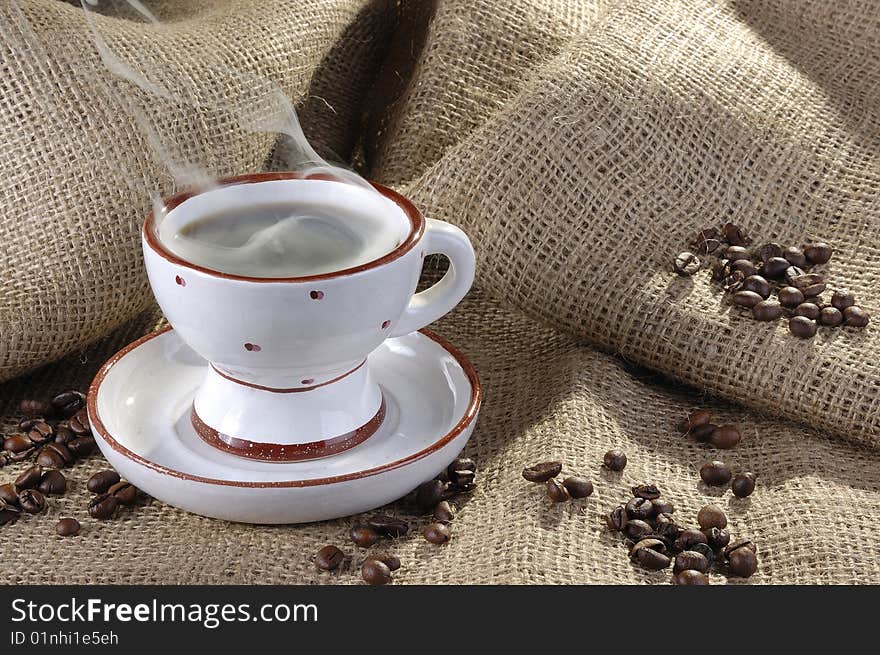 Cup of coffee with coffee grains