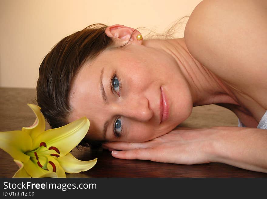 Attractive woman with flower relaxing in spa. Attractive woman with flower relaxing in spa