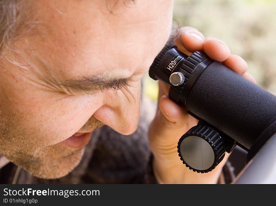 Scientist observing through his microscope. Scientist observing through his microscope