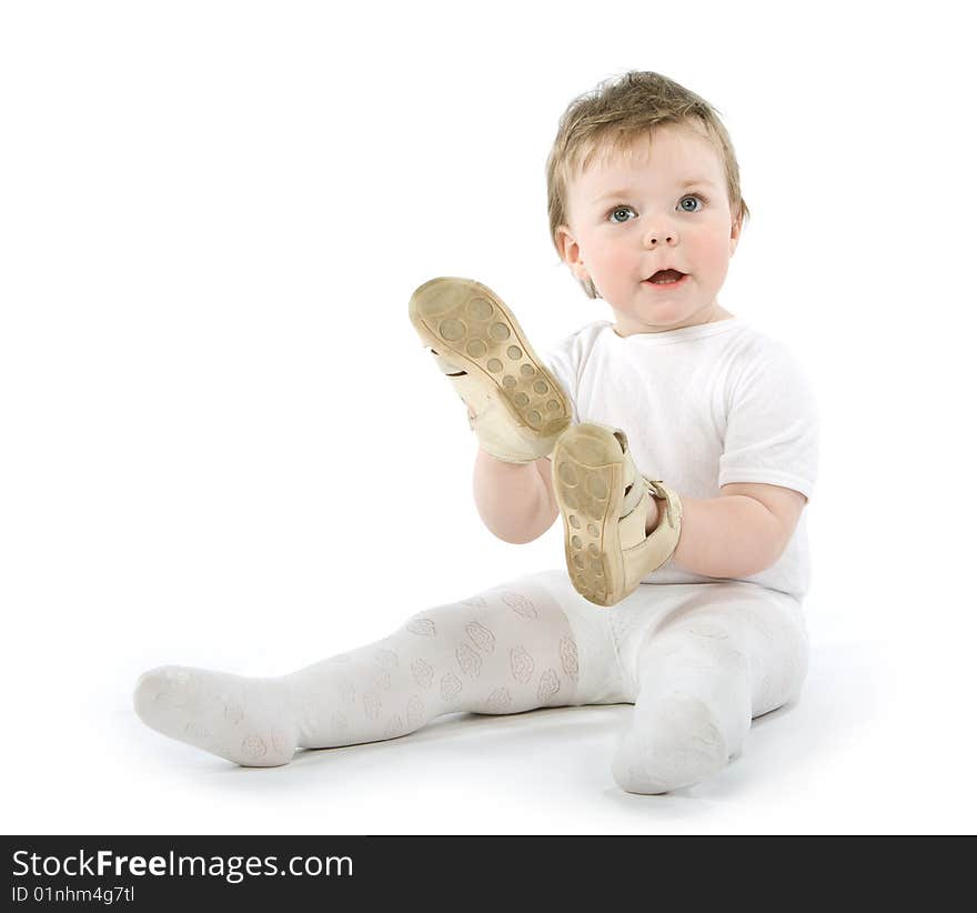 Child with shoes sitting. Isolated on white