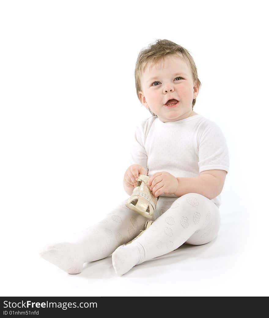 Child with shoes sitting. Isolated on white