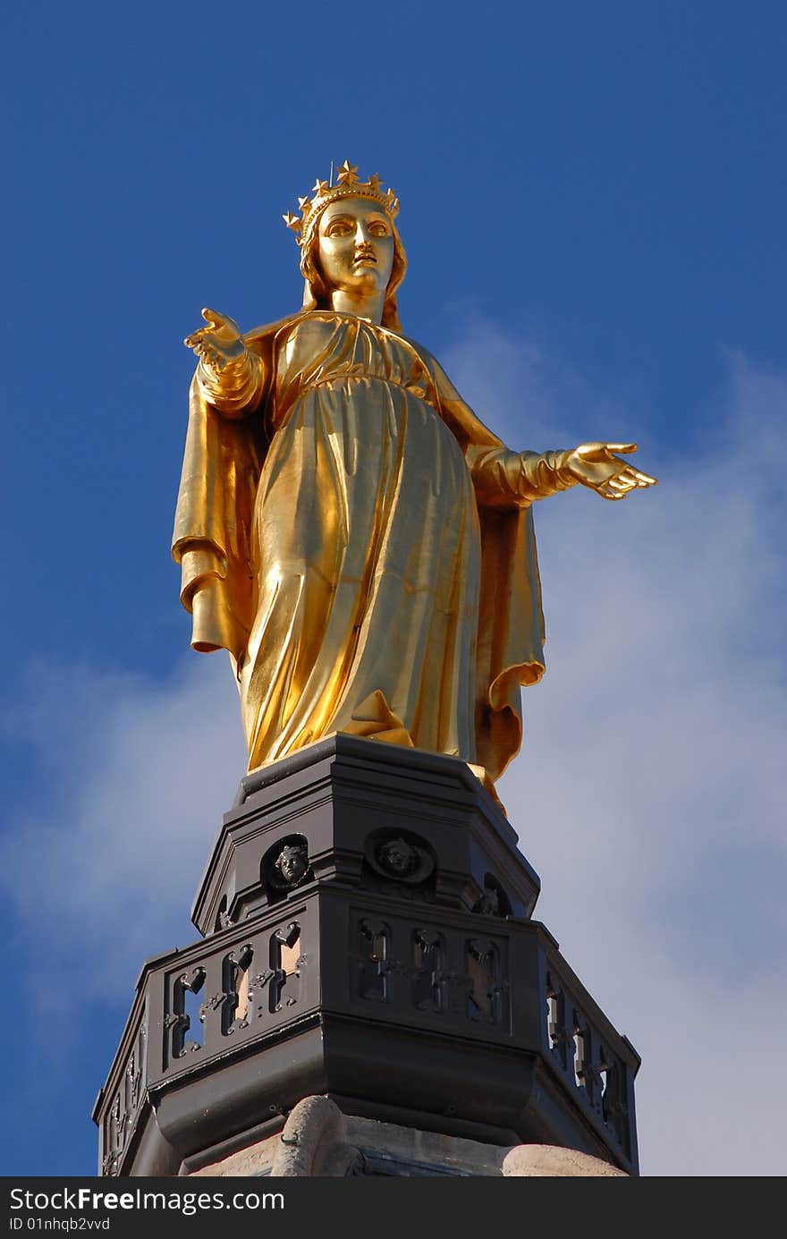 A gilded statue of the Virgin Mary stands on top of the Notre Dame Cathedral at Fourviere Hill in Lyon, France. A gilded statue of the Virgin Mary stands on top of the Notre Dame Cathedral at Fourviere Hill in Lyon, France.