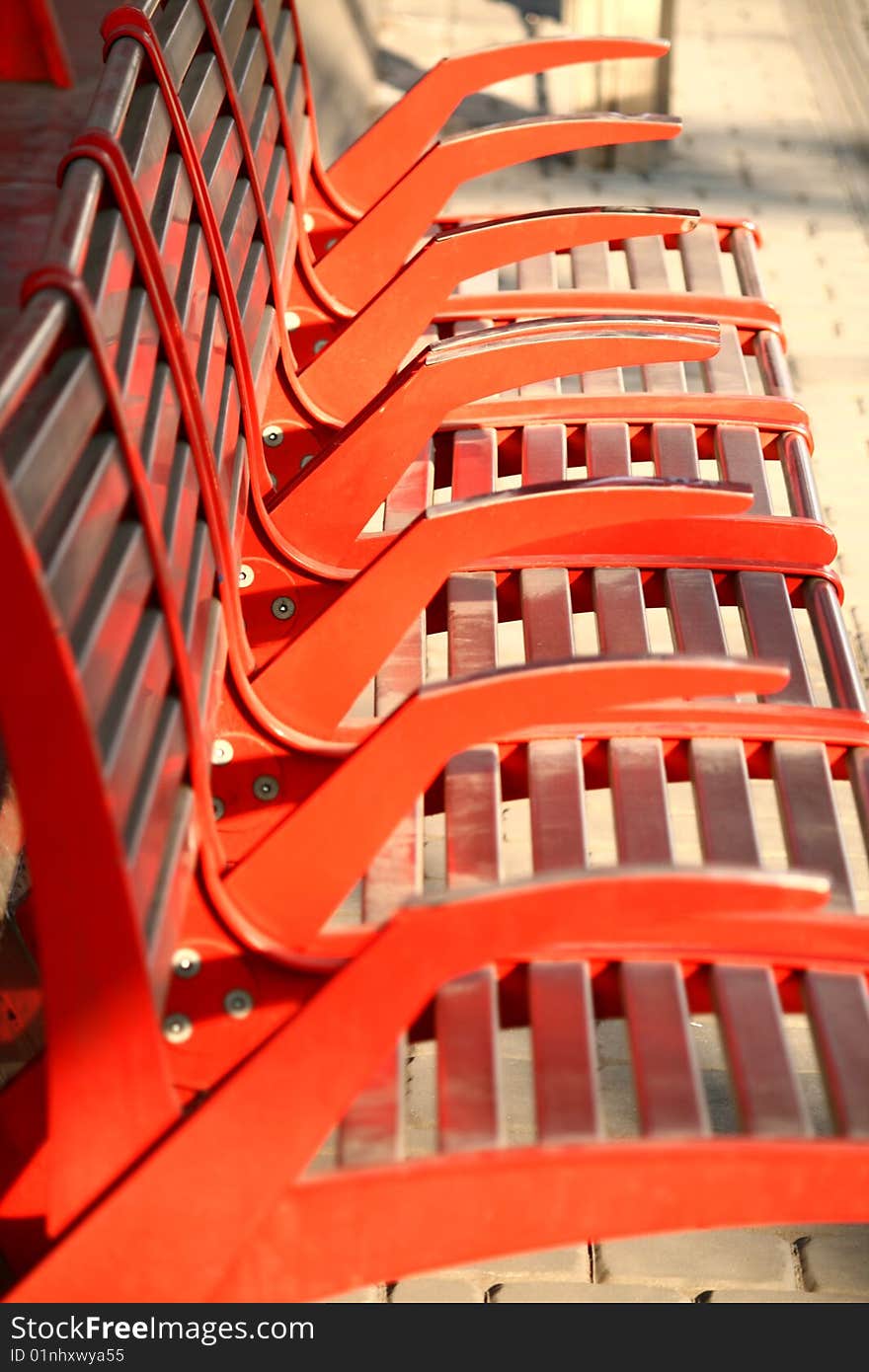 The detail of the red iron benches on the tram stop Chaplin sqaure, Barrandov district, Prague, Czech republic. The detail of the red iron benches on the tram stop Chaplin sqaure, Barrandov district, Prague, Czech republic.