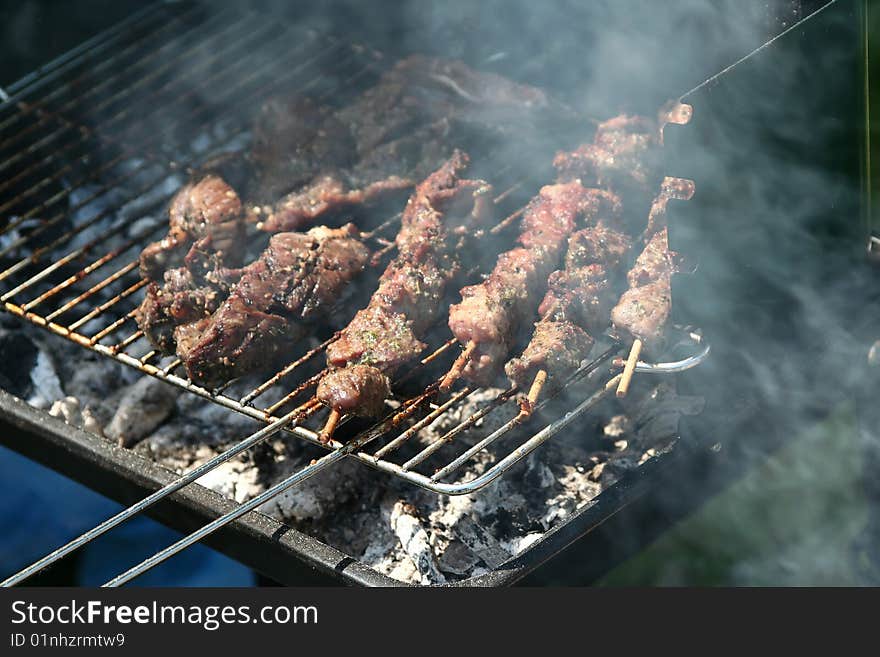 Sausages and chicken kebabs on a barbecue. Sausages and chicken kebabs on a barbecue