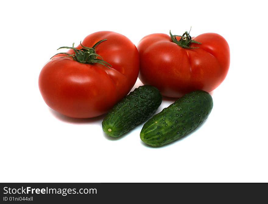 Fresh tomatoes and cucumbers on a white background. Fresh tomatoes and cucumbers on a white background