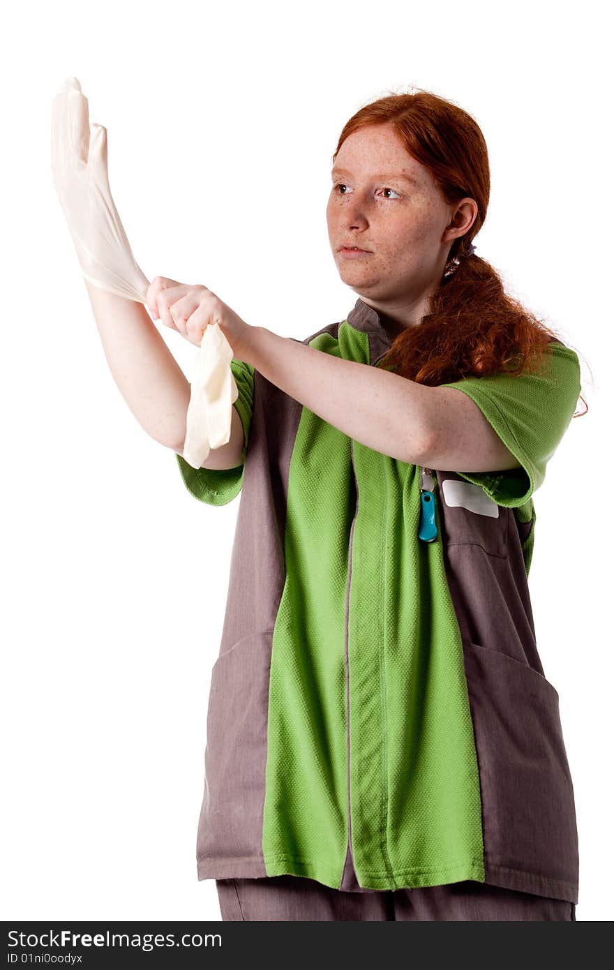 Red haired health care taker putting on her gloves