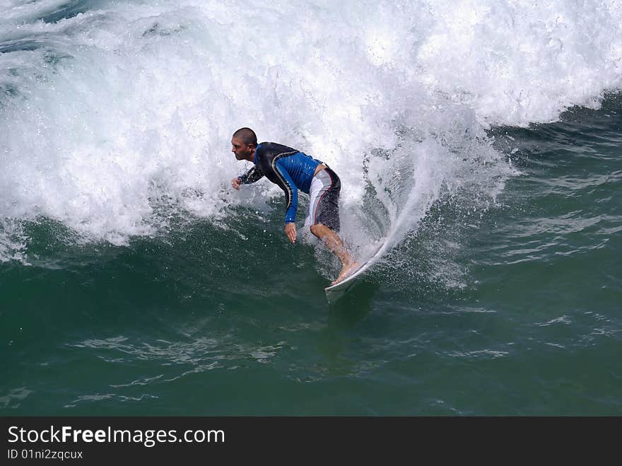 Young man in a wetsuit surfing. Young man in a wetsuit surfing