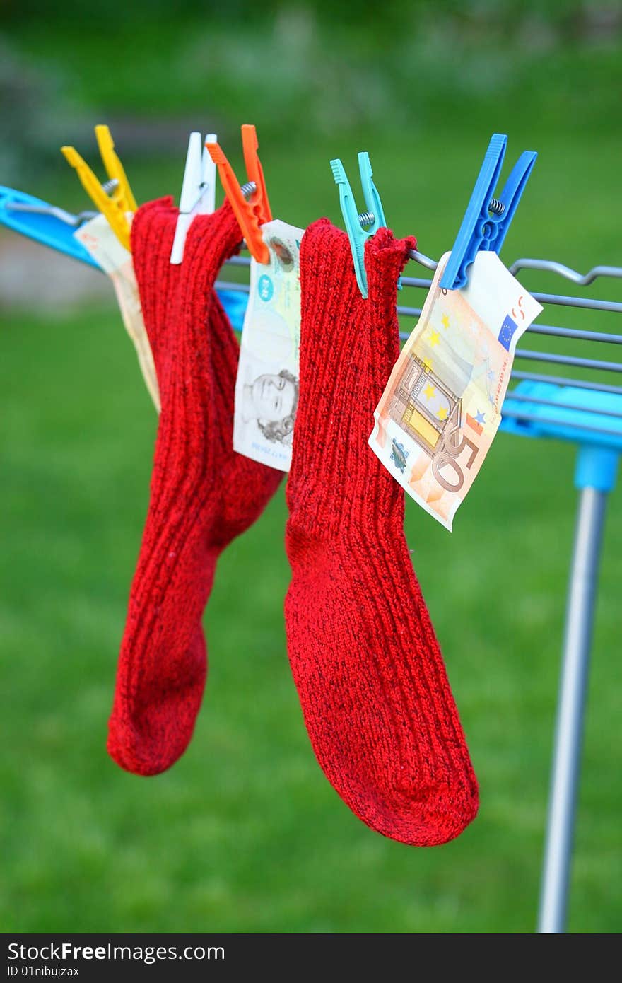 Two red socks and some banknotes. Two red socks and some banknotes