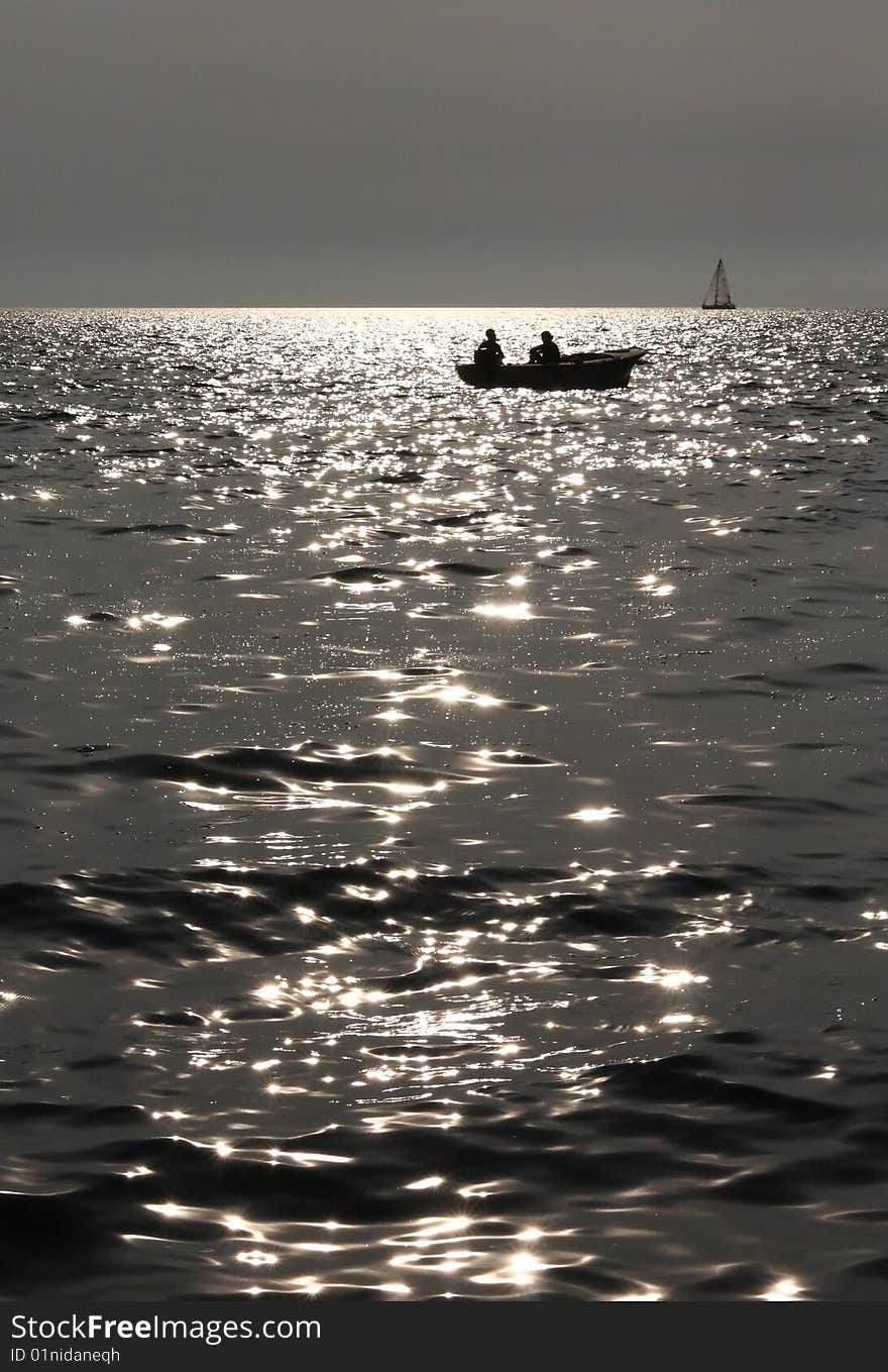 Silhouette of two fishermen in the boat. Silhouette of two fishermen in the boat