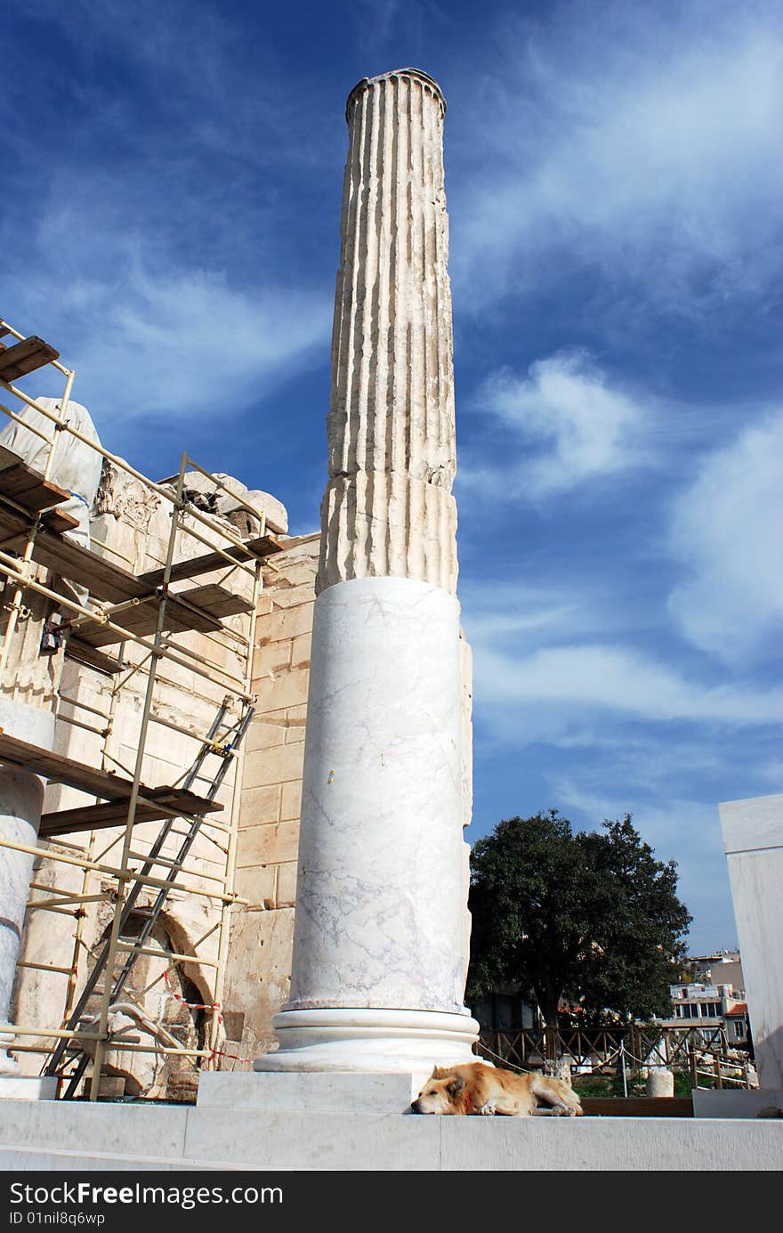 The dog sleeping next to the column in Athens' archaeological site (Greece). The dog sleeping next to the column in Athens' archaeological site (Greece).