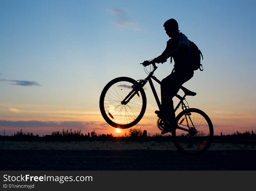 Boy on a bicycle in the sunset