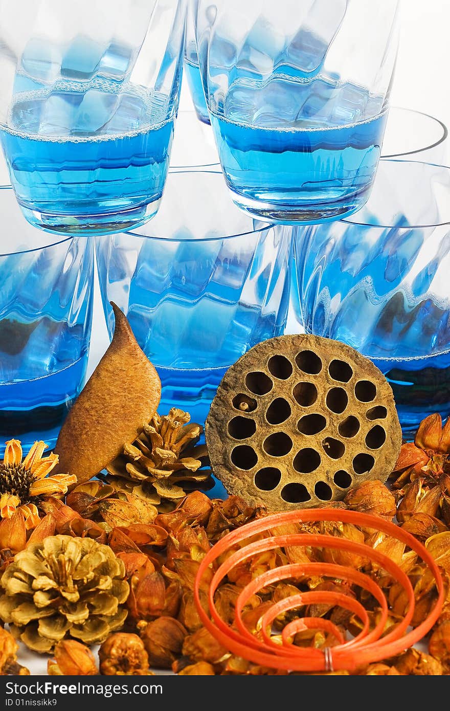 Cocktails blue and composition of dried flowers on a white background. Cocktails blue and composition of dried flowers on a white background