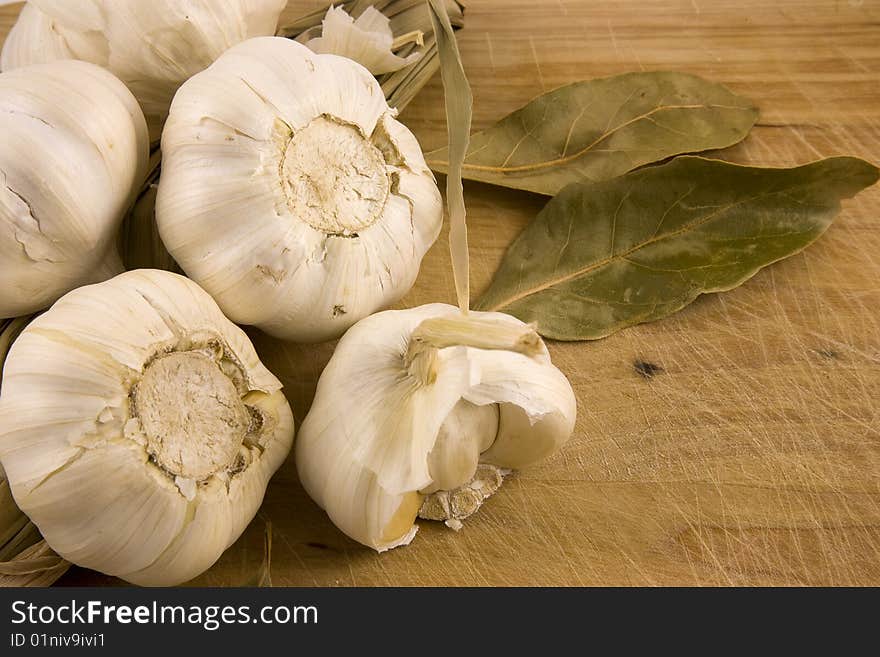 a set of Mediterranean ingredients over a wooden board ready to be chopped and used to flavour a meal. a set of Mediterranean ingredients over a wooden board ready to be chopped and used to flavour a meal