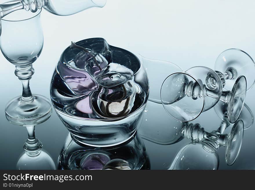 Wine glasses and abstract glass over mirror. Wine glasses and abstract glass over mirror