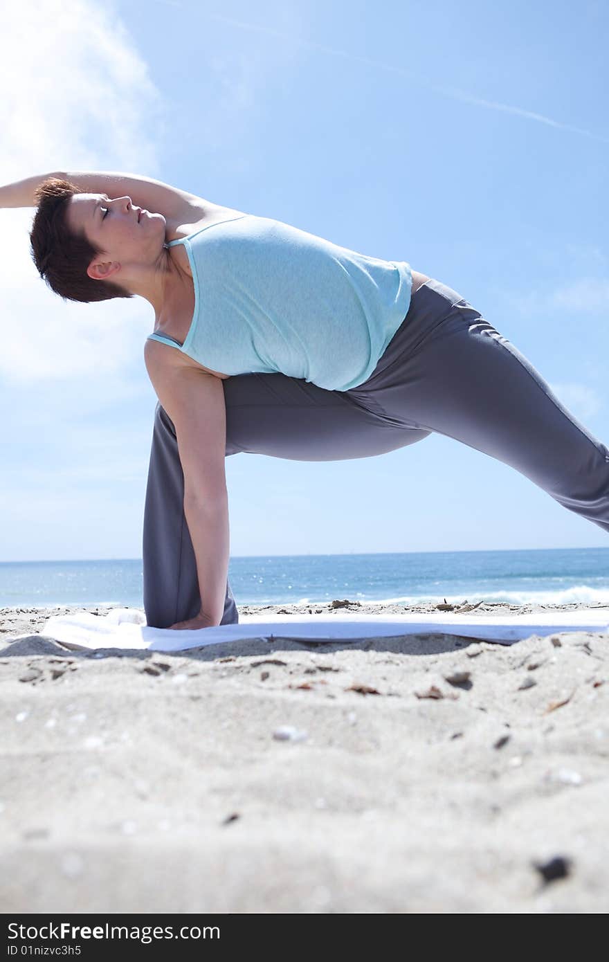 Woman Practicing Yogo at the Beach