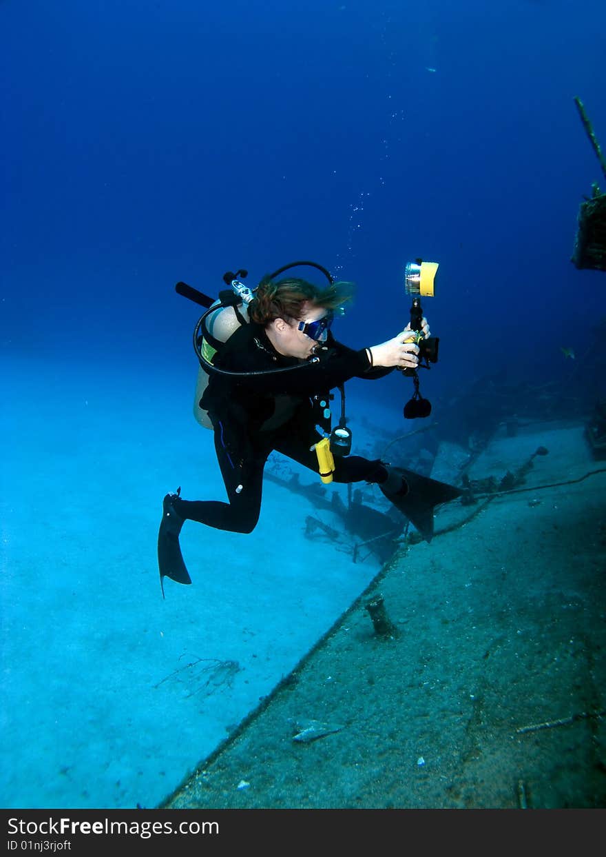 A Female Professional Underwater Photographer shooting the MV Tibbetts in Cayman Brac. A Female Professional Underwater Photographer shooting the MV Tibbetts in Cayman Brac