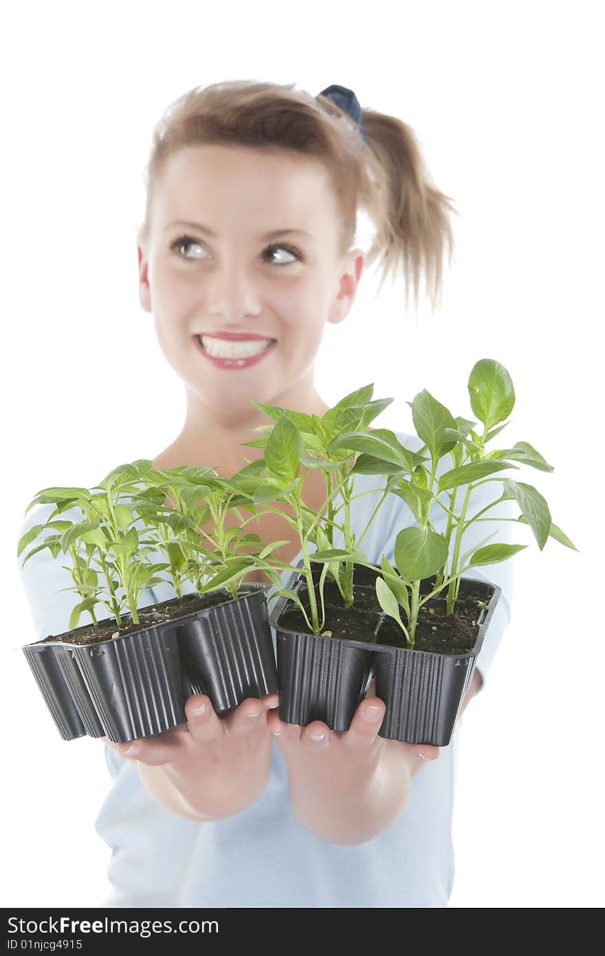 Smiling girl holding young plants