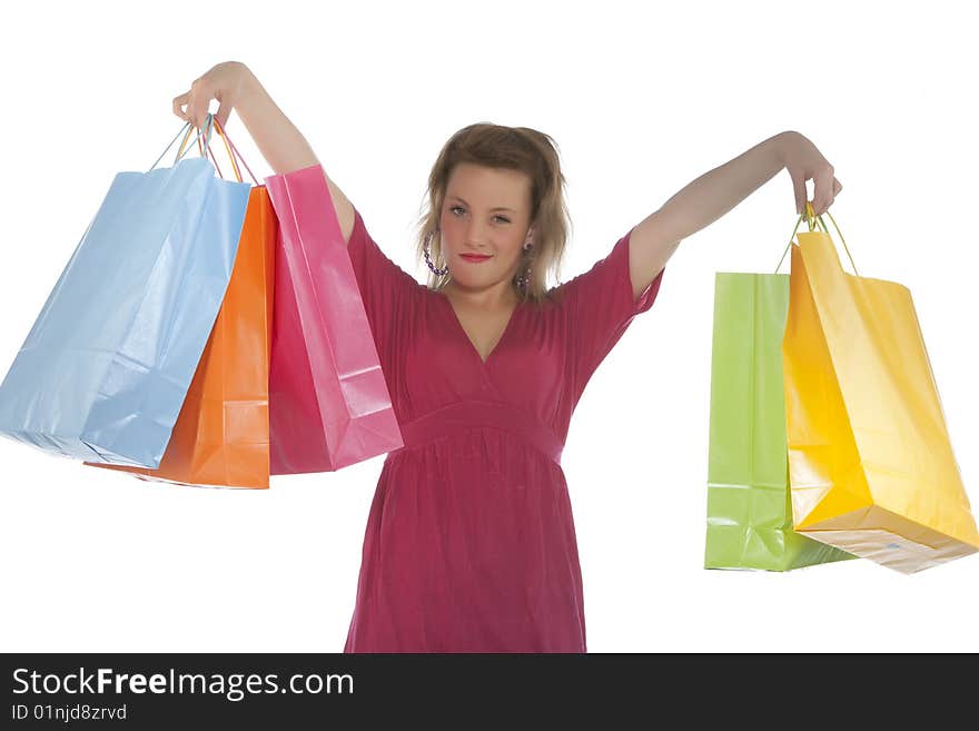 Attractive young woman holding several shoppingba