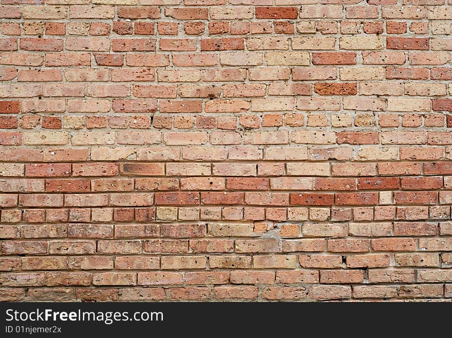 Old crumbling red brick wall background texture. Old crumbling red brick wall background texture