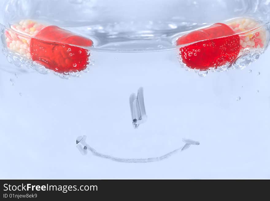 Take pills and get healthy again: concept with pills, water and smile