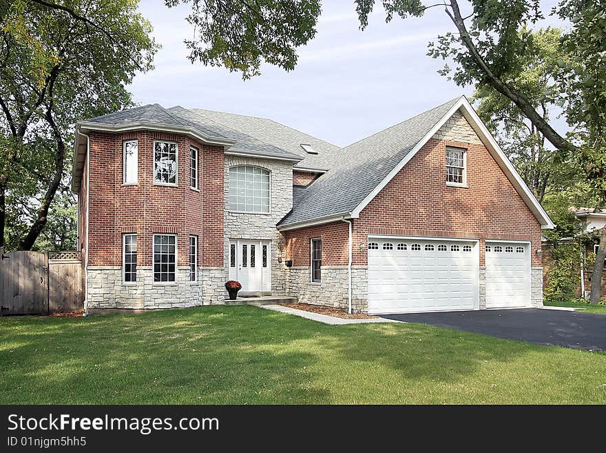 Brick home in suburbs with stain glass windows