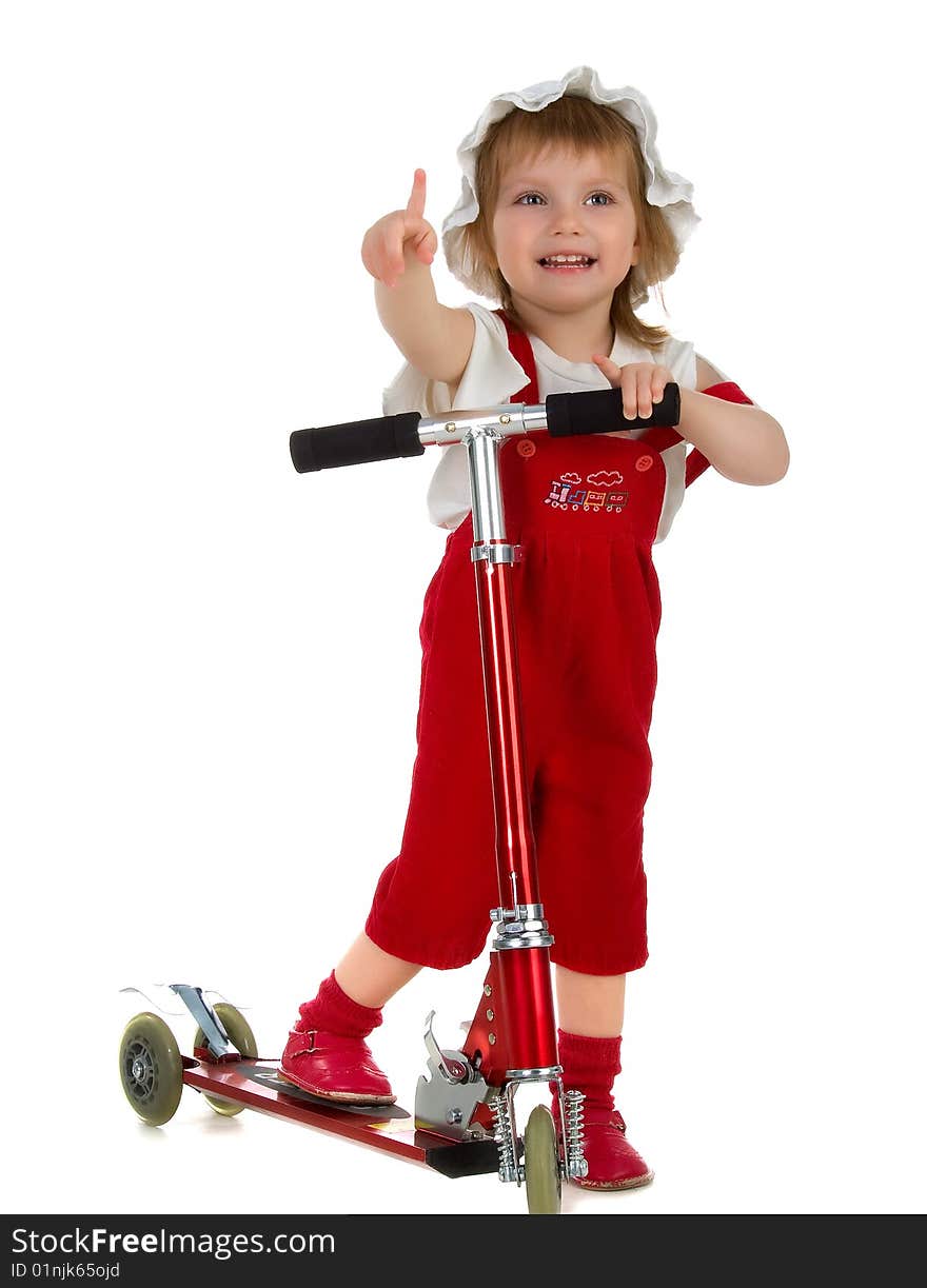 Little girl and her scooter. Studio isolated