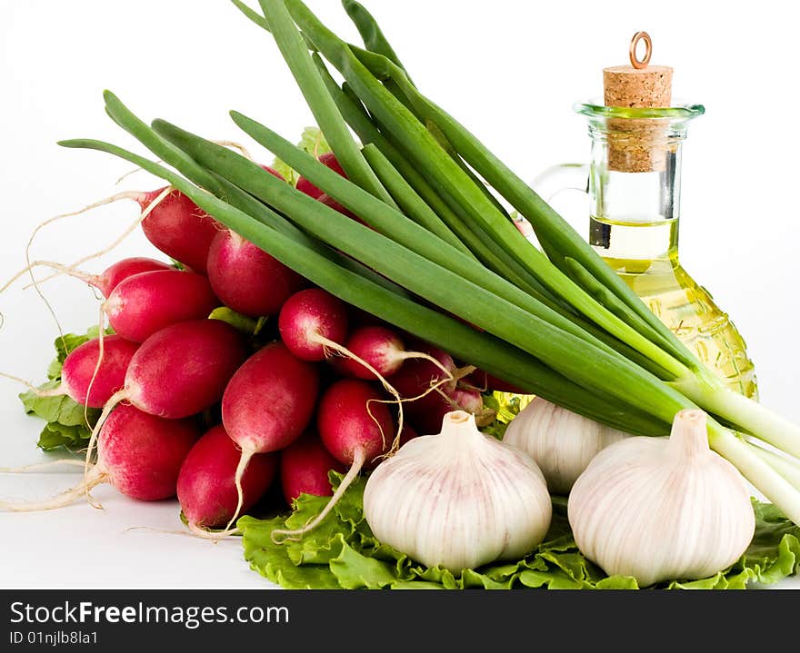 Green vegetables and a bottle of olive oil on the white background. Green vegetables and a bottle of olive oil on the white background