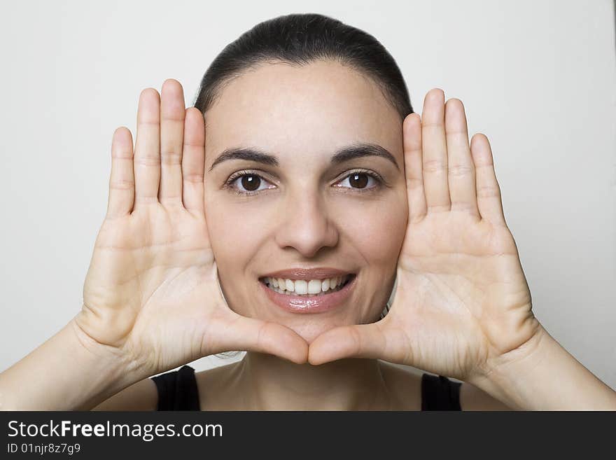 Young woman frame her face with palms. Young woman frame her face with palms