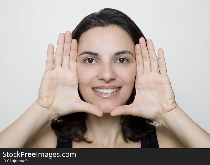 Young woman frame her face with palms. Young woman frame her face with palms