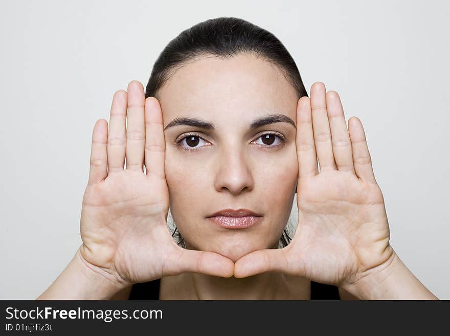 Young woman frame her face with palms. Young woman frame her face with palms