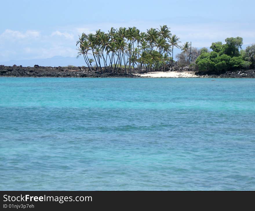 The lovely blue waters of Hawaii with a pocket of white sand beach. The lovely blue waters of Hawaii with a pocket of white sand beach.