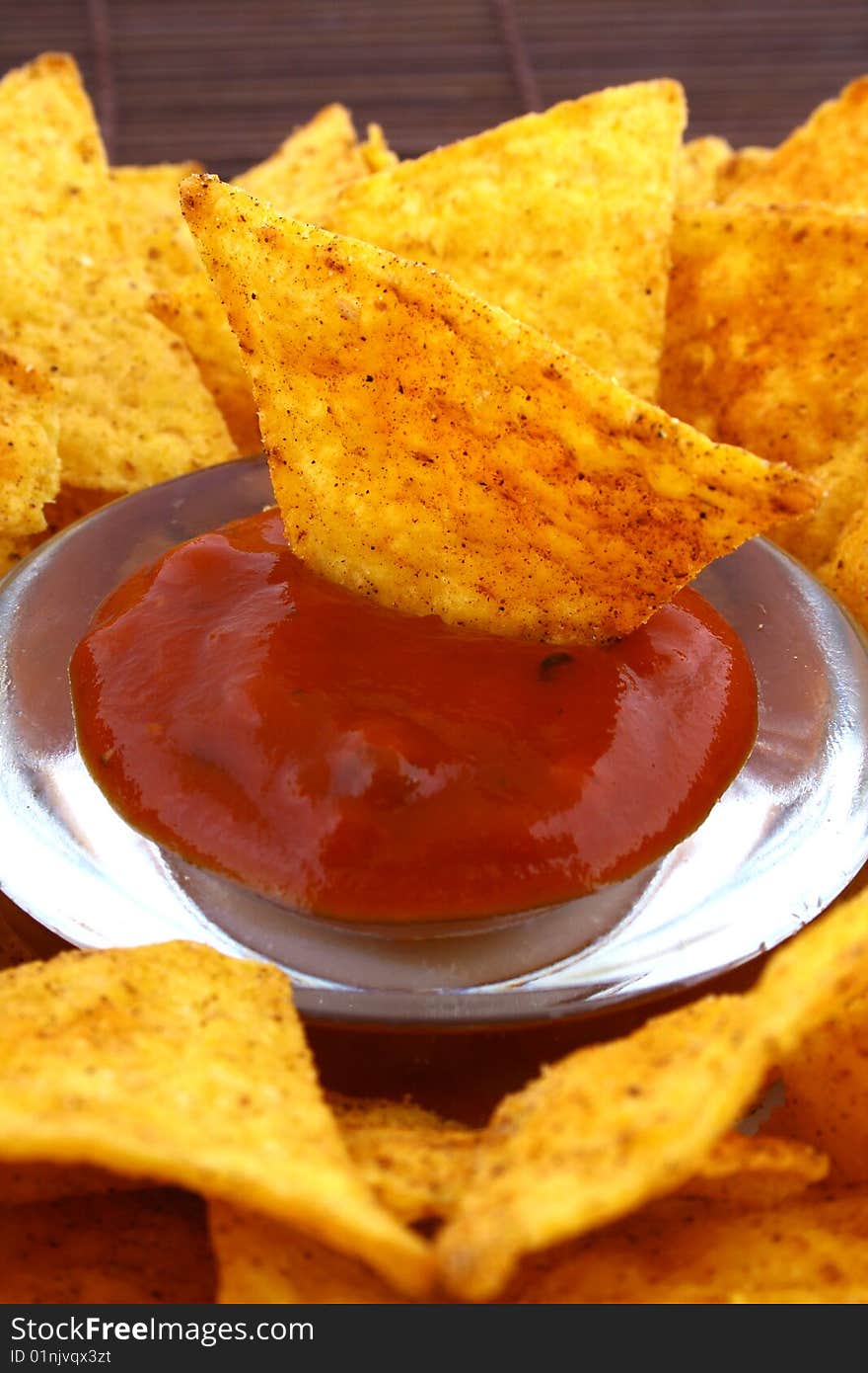 Salsa dip in a bowl on brown background