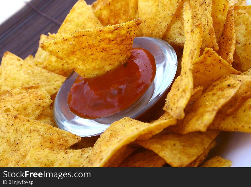 Salsa dip in a bowl on brown background